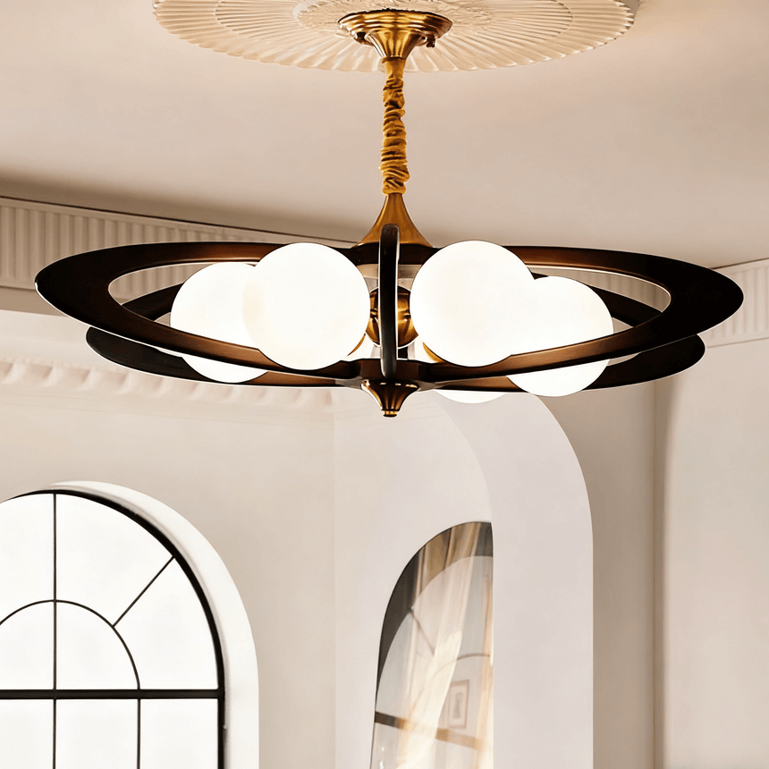 The rings lit beside an arched window in a plain plaster room