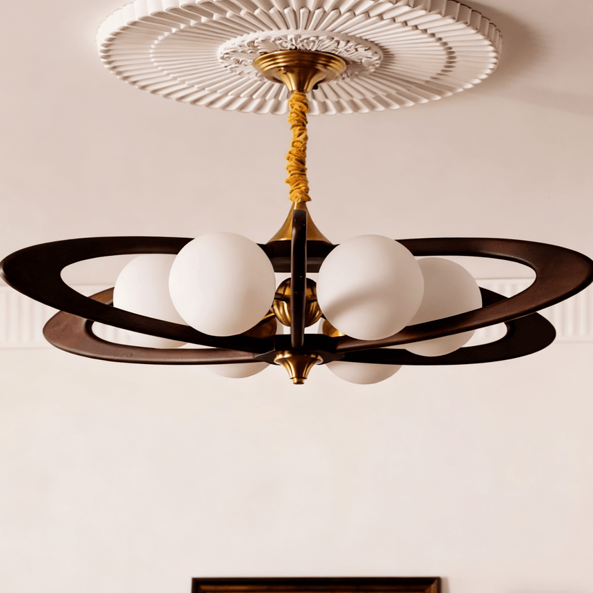 White opal globes lit close, the dark rings crossing behind them
