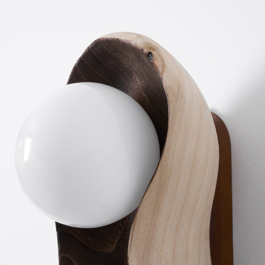 Close view of an opal globe where it sits down inside the wood hollow