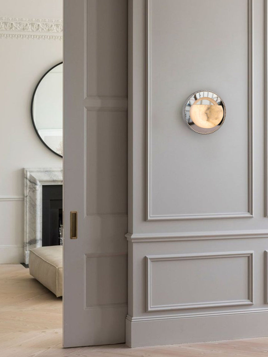 The orbit light on a paneled wall beside an open doorway