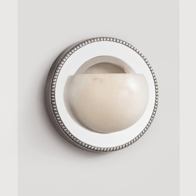 The orbit light on a pale background, showing the beaded rim