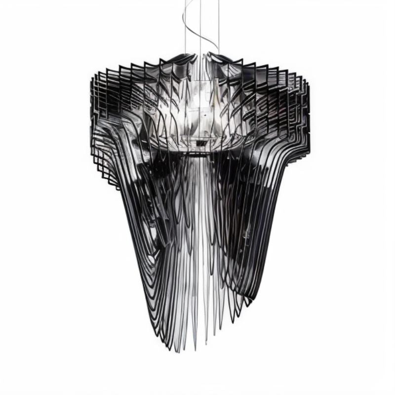 The same flowing form in black acrylic, layers fanning out around a lit core