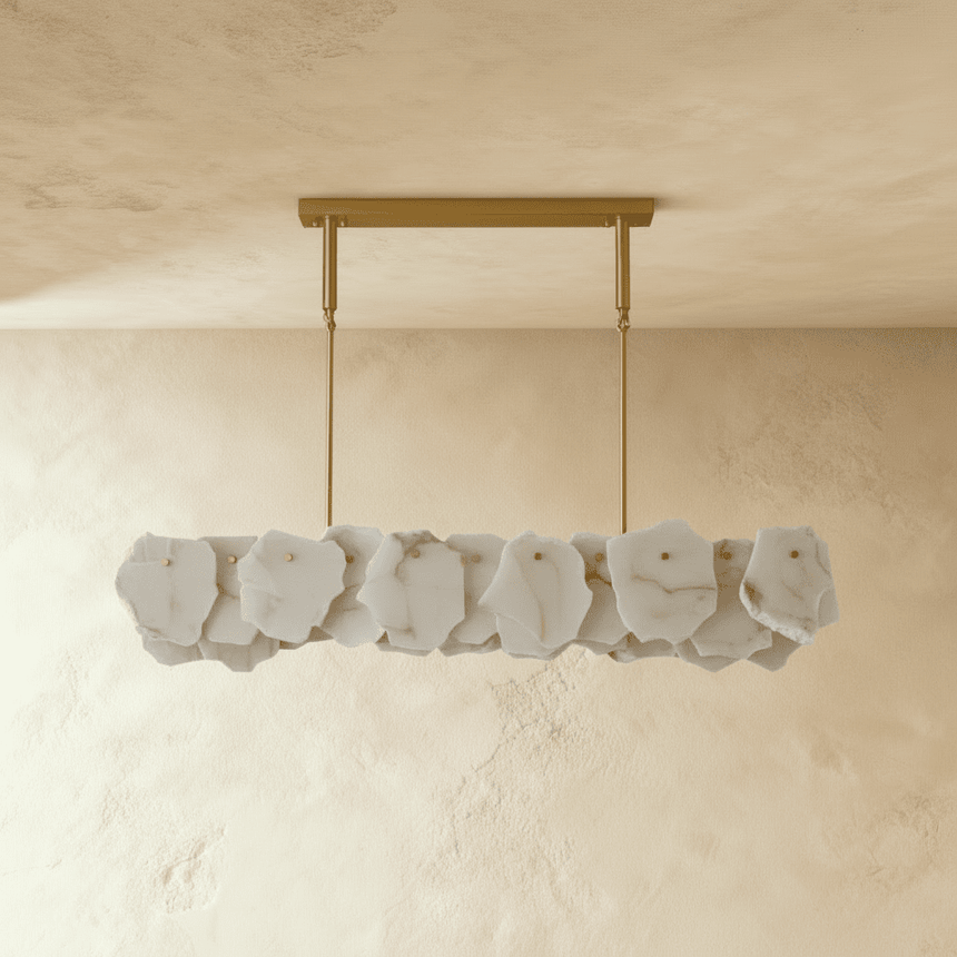 A linear bar of gray stone petals below a brass ceiling plate