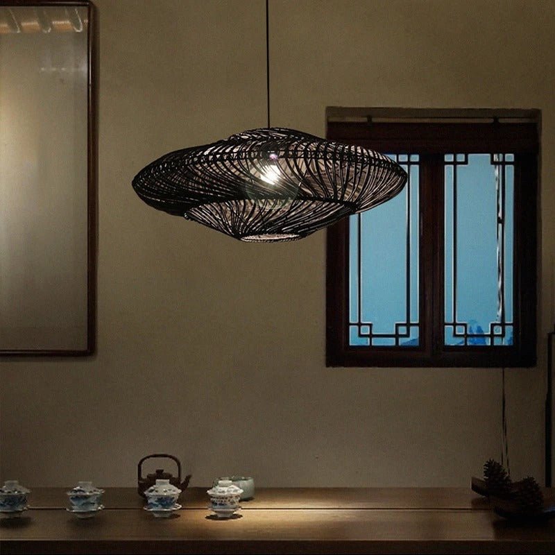 The shade lit in a dark room beside a tall mirror and an open doorway