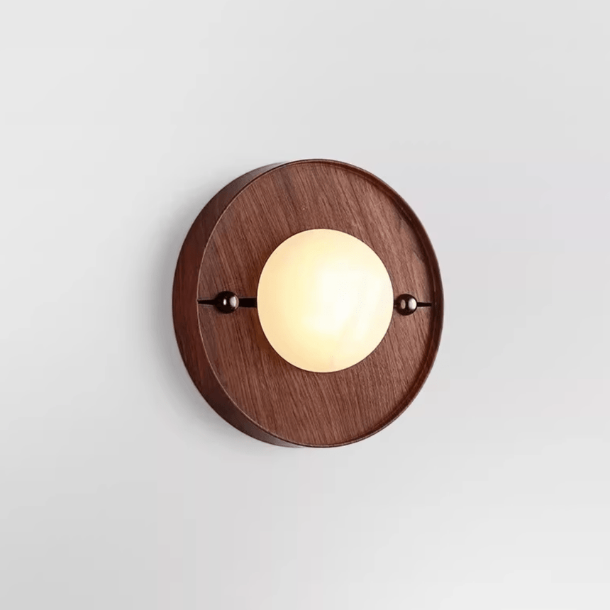 The round walnut plate version with a pale disc set proud of its face