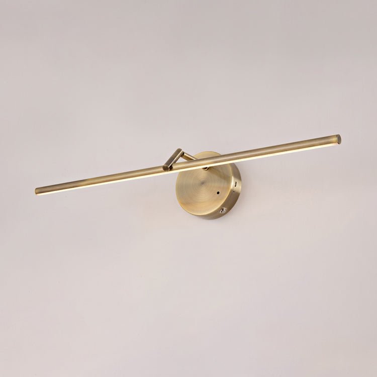 The bronze finish seen against a soft pink wall, rod and disc mount in profile