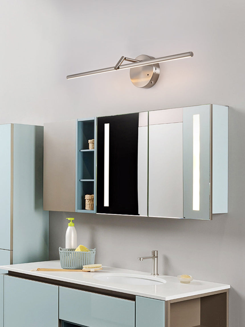 Lit over a mirrored bathroom cabinet above a basin and a pale blue vanity unit