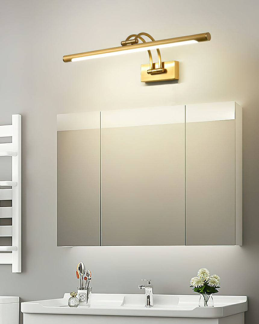 Brass bar lit above a wide mirror cabinet over a white basin in a pale bathroom