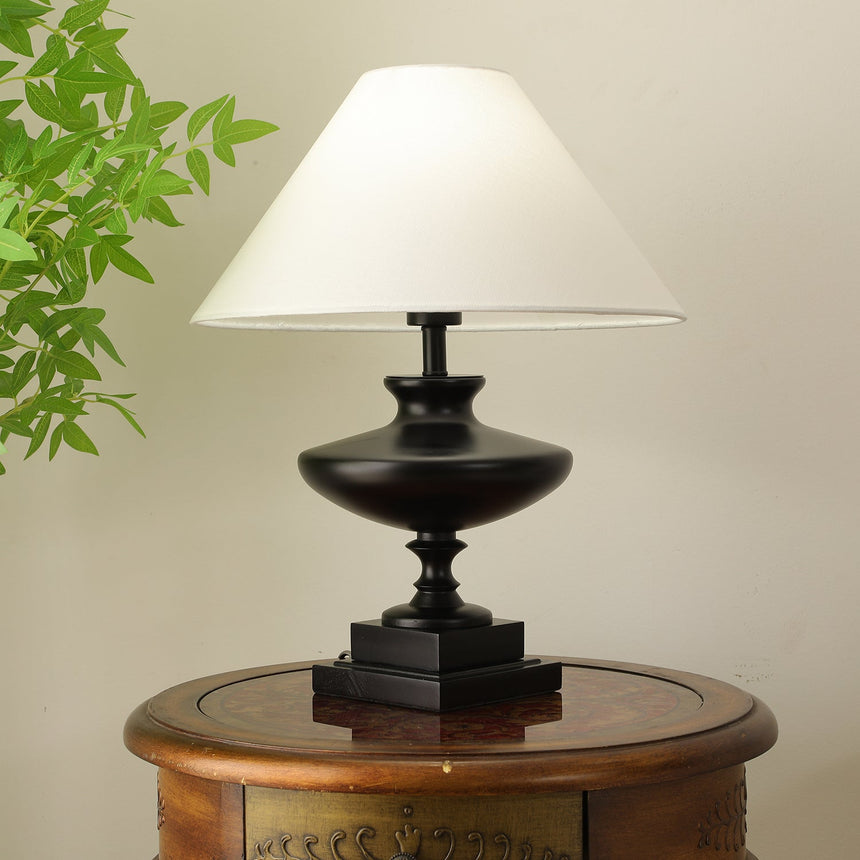 Close view of the turned black urn body on its stepped square plinth