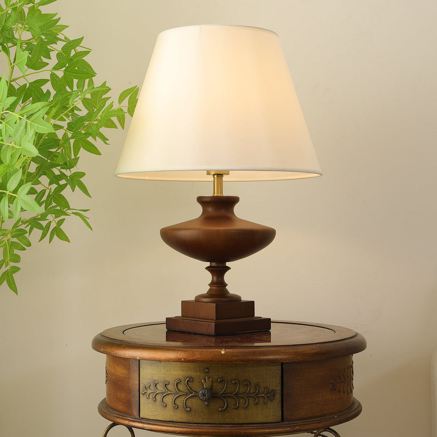 Close view of the turned walnut urn body on its stepped square plinth