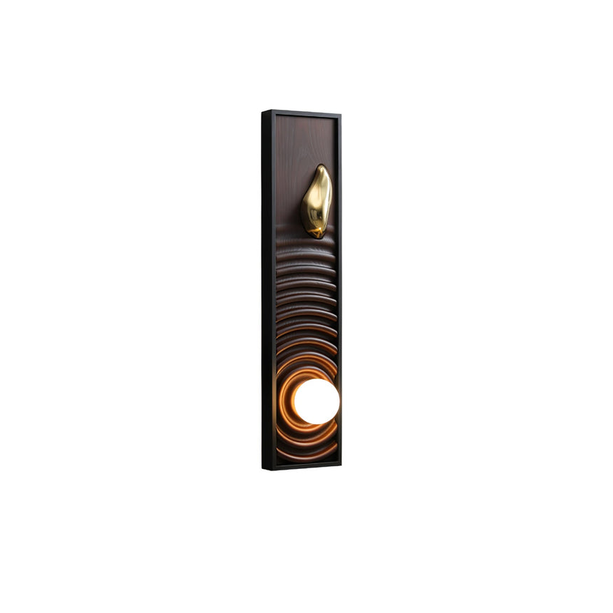 Walnut panel carved in ripples inside a black frame with the orb lit below