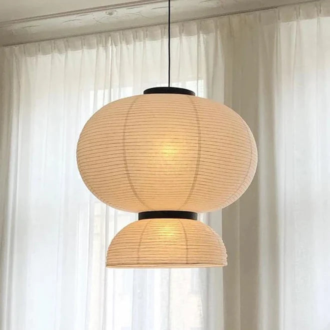 Single rice paper lantern lit against a pale curtain