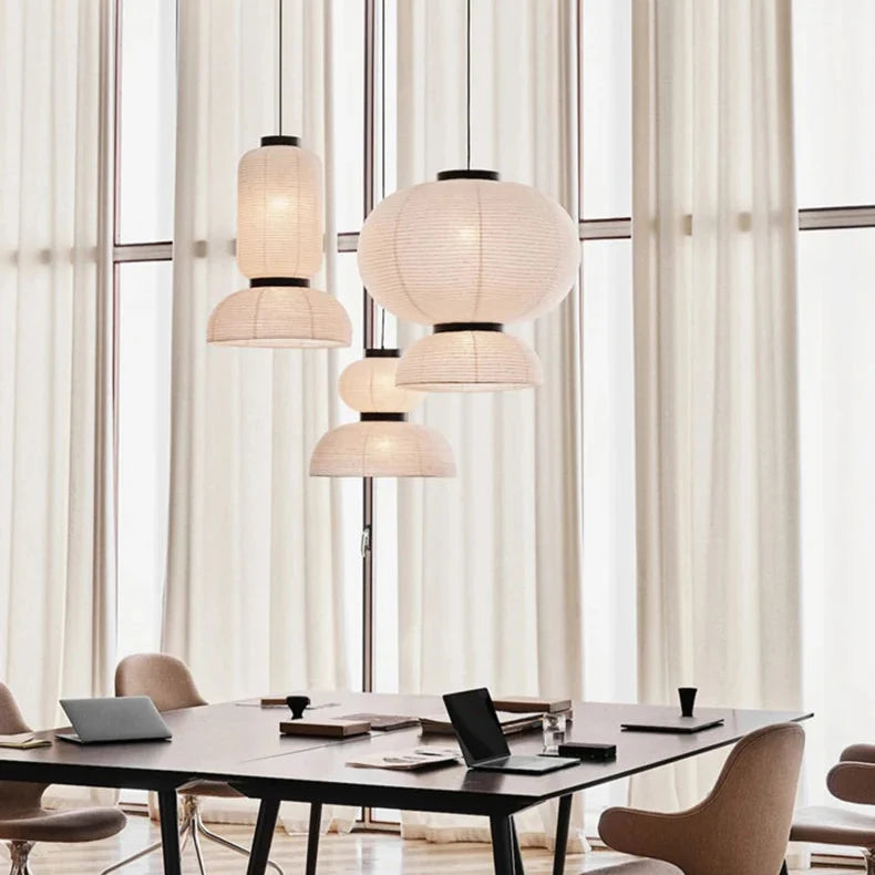Rice paper lanterns hung above a table in a bright room with curtains