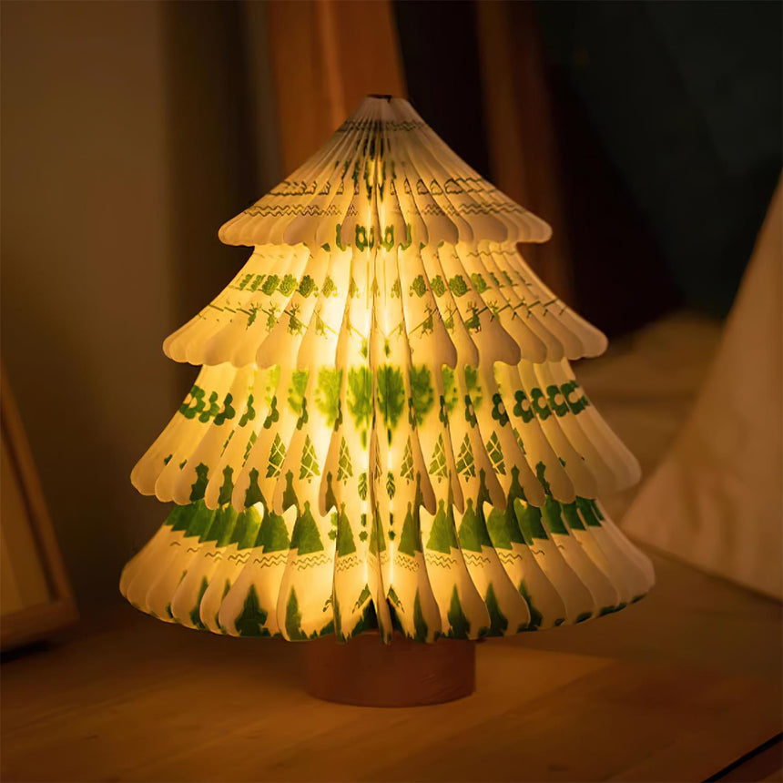Close view of the green paper tree lamp lit, the folded tiers visible