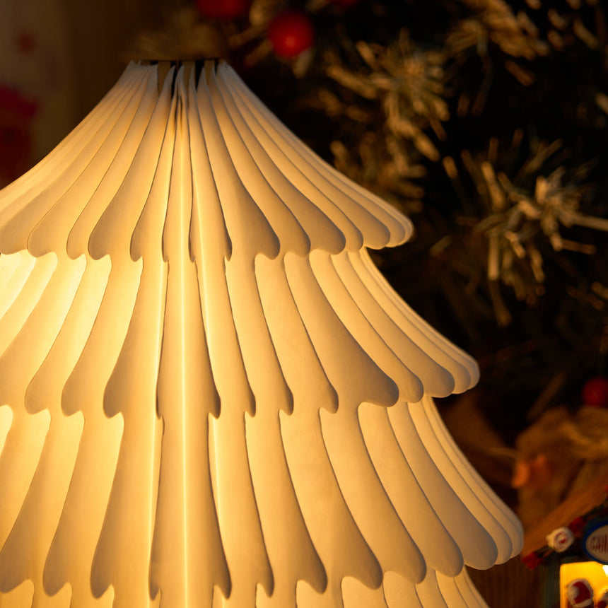 Close view of the lit paper tiers showing the folds and cut edges