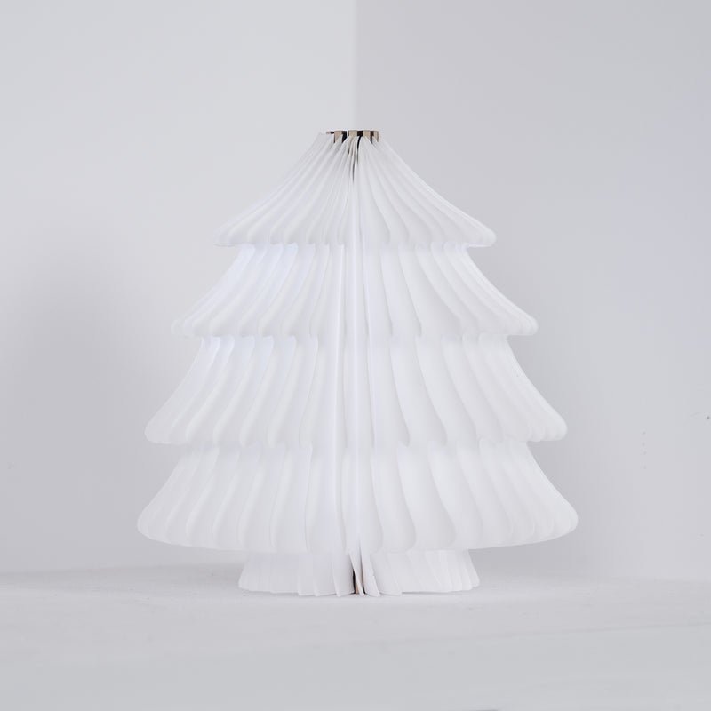 White folding paper tree lamp unlit against a plain pale ground