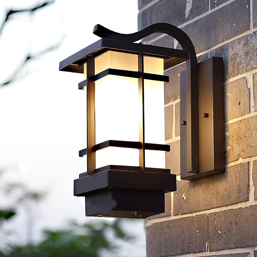 The lantern on a dark brick wall seen at an angle, the frosted glass unlit