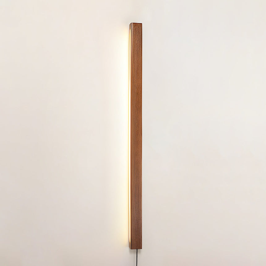Slim pine bar mounted vertically and lit against a plain pale wall