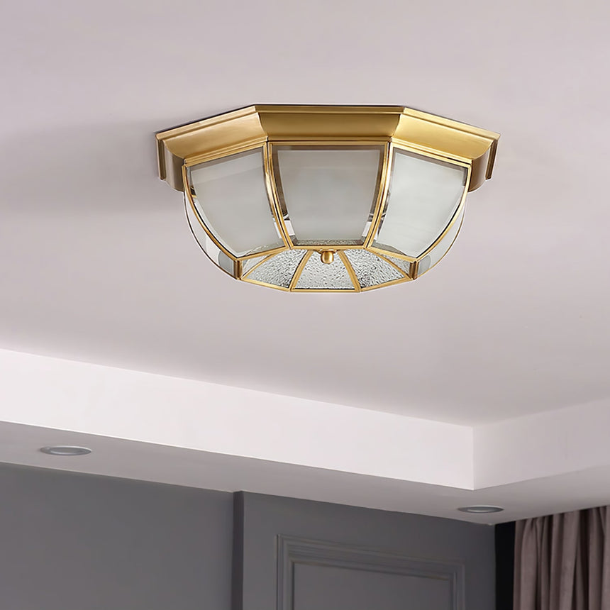 Octagonal brass ceiling light on a plain ceiling seen at an angle