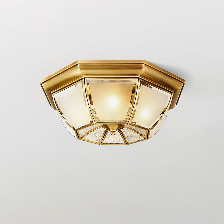 Octagonal brass ceiling light on a white ceiling corner