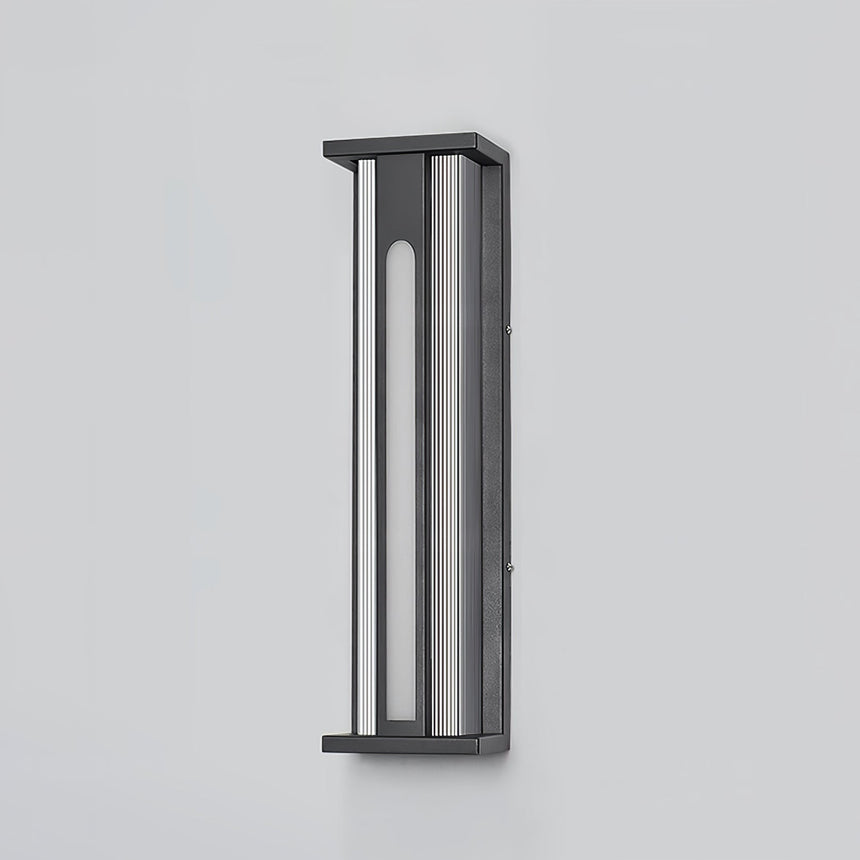 The lantern unlit against a plain wall, the frame and tinted panels visible
