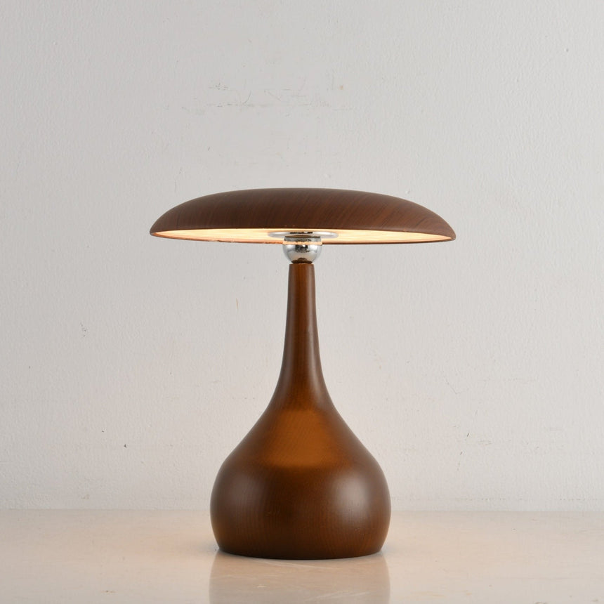 Portable table lamp on a teardrop base with the disc lit