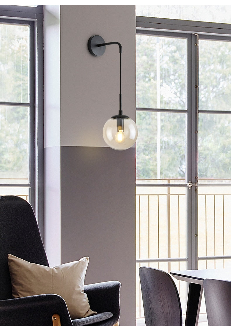 Amber glass shade on black wall sconce