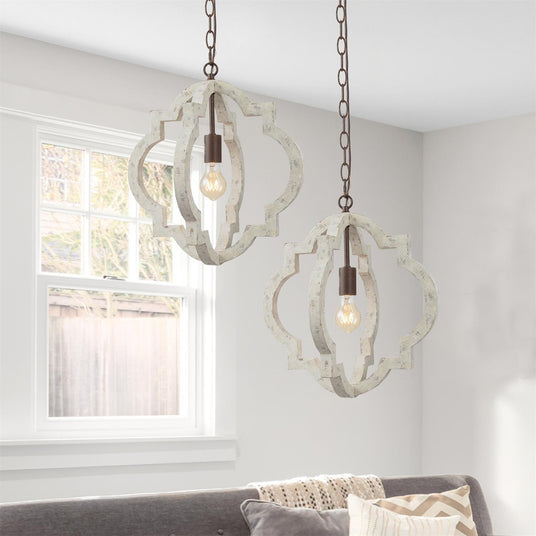 A pair of them hung in a living room above a sofa beside a bright window