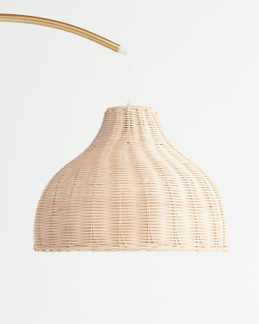 The woven wicker shade seen close, the open weave and the brass arm above