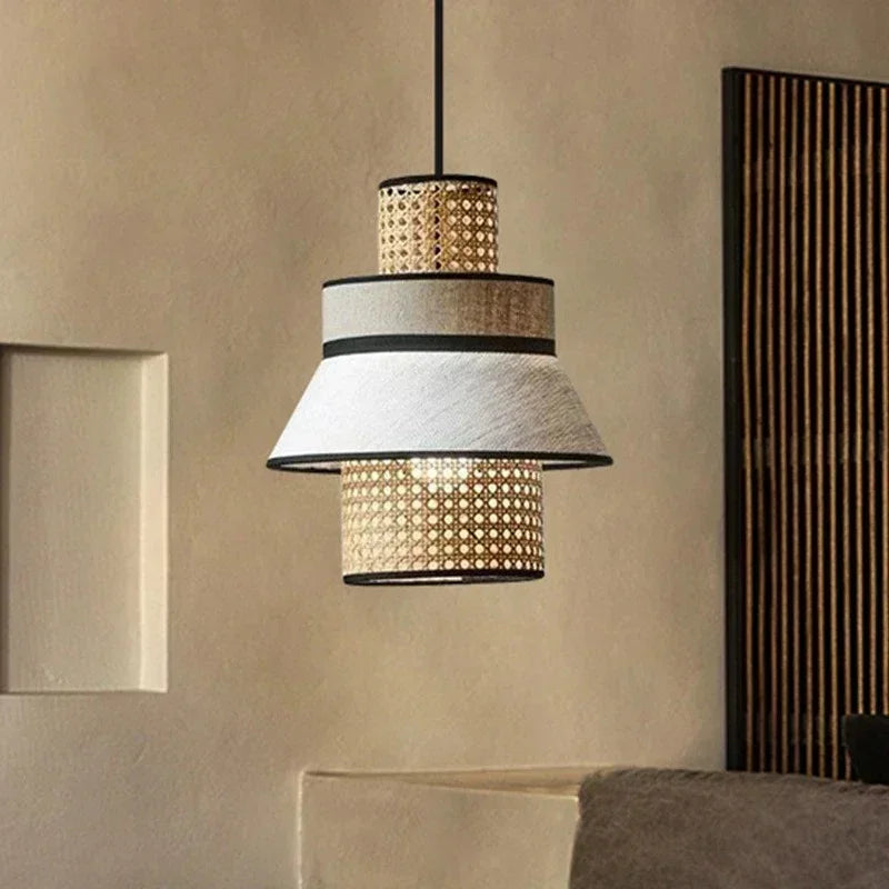 Rattan hanging light with a woven upper band and a fabric lower band, lit in a room