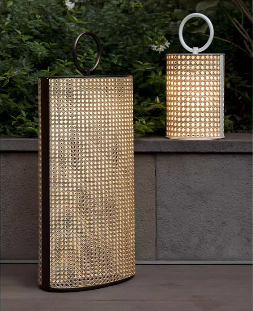 The lantern lit beside a concrete garden wall with a smaller one above