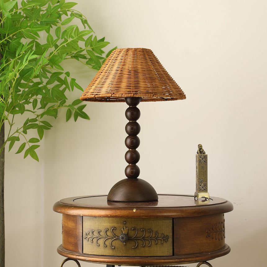Close view of the woven rattan shade above the beaded stem