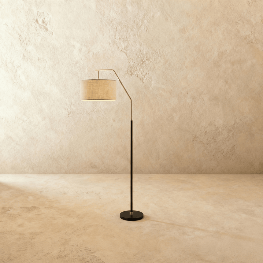 The same lamp in black, the drum shade tilted forward on a short angled arm