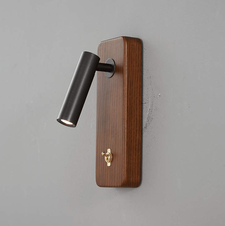 Dark finished reading head on a vertical ash wood plate, angled down