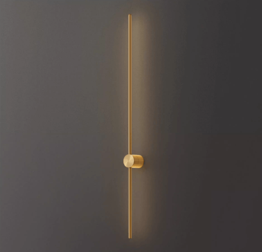 The copper rod lit against a dark wall, the warm metal catching the glow