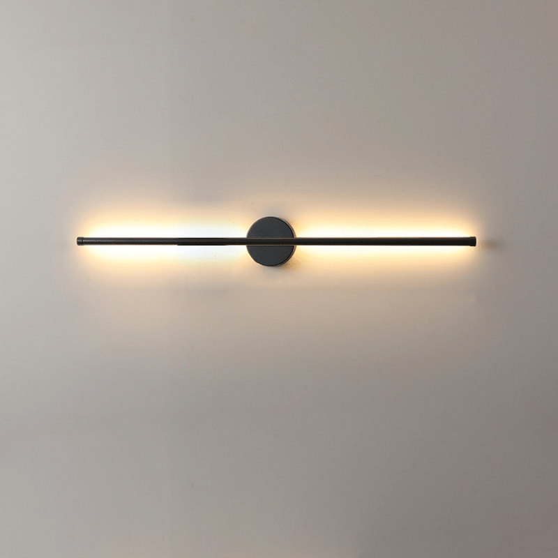 The bar lit warm on a pale wall, the glow spreading evenly to both ends