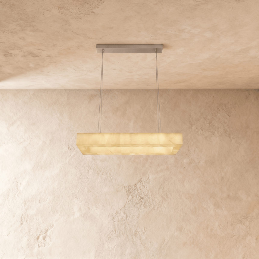 A long rectangular alabaster bar lit below a slim ceiling plate