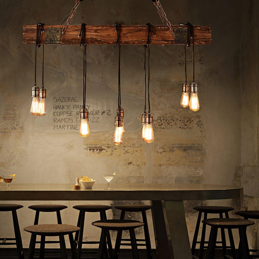 Lit over a run of stools and a counter against a concrete wall with lettering
