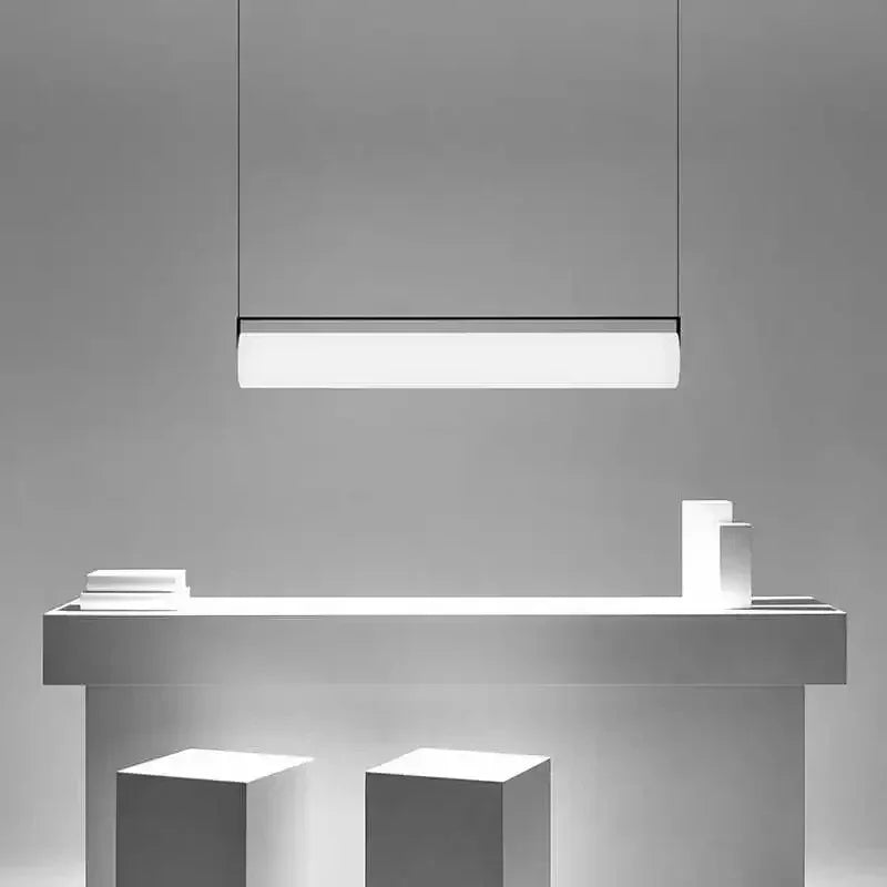 The flat lit bar hung above a pale counter with two stools