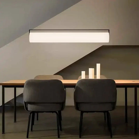 The flat lit bar hung under a sloped ceiling above a table and chairs