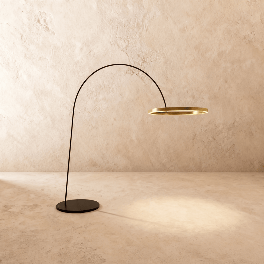 A thin black arm curving from a flat disc base to a lit gold ring at its end