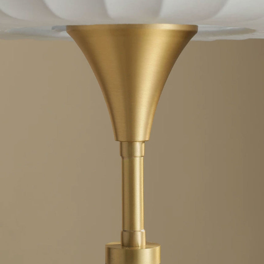 Close view of the brass trumpet where the stem meets the shade