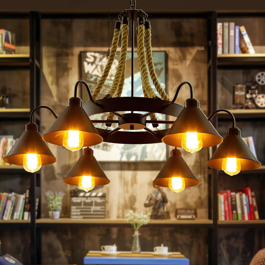 The fitting lit in a room lined with bookshelves and a wood table