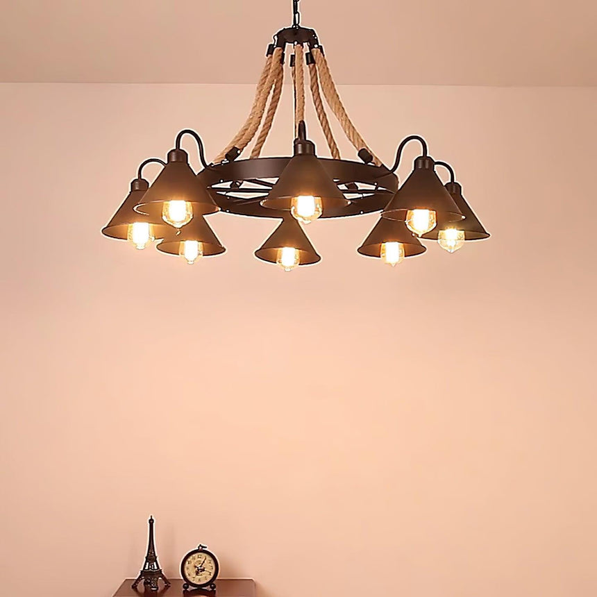 The chandelier lit warm in a room with a soft pink wall behind