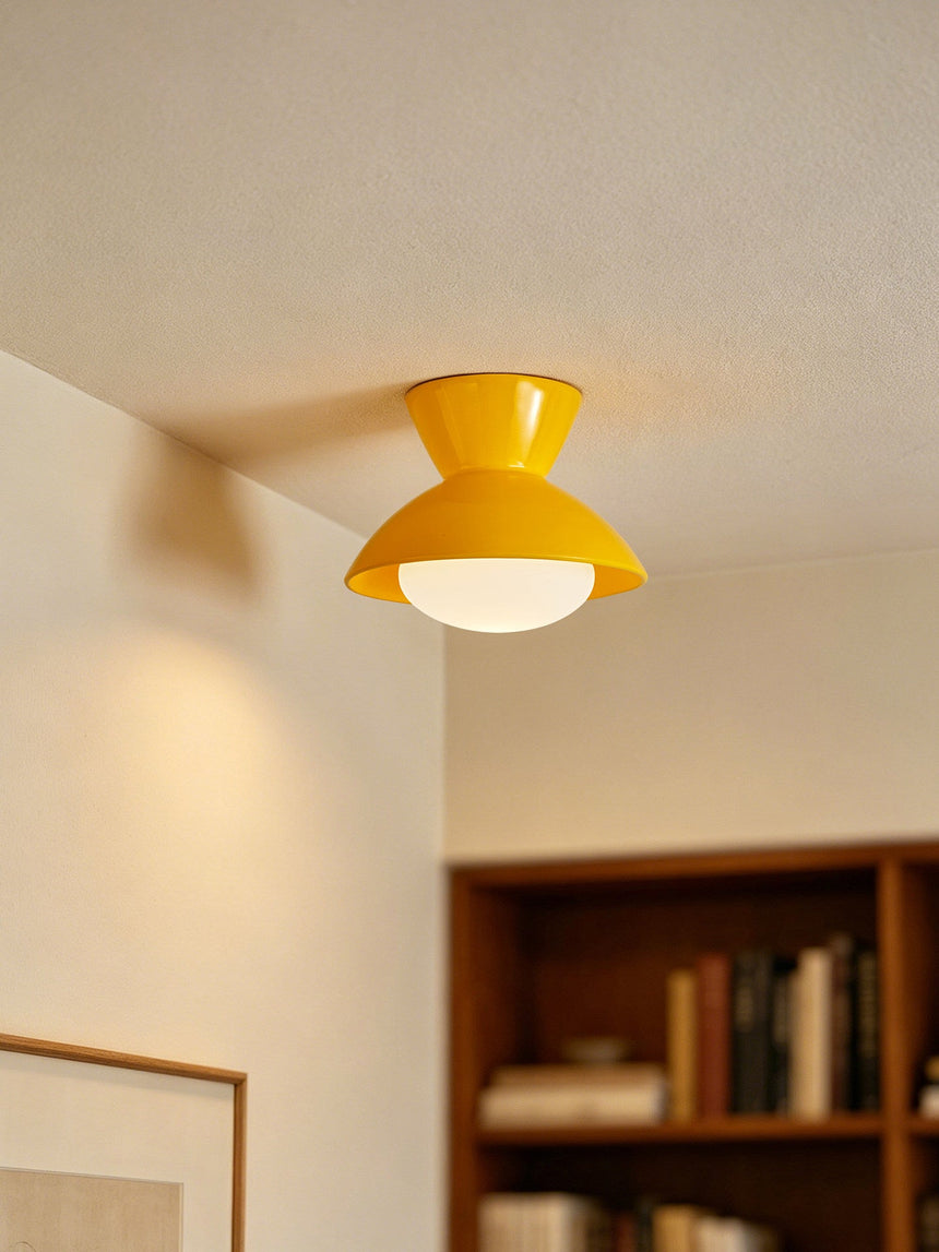 Yellow gourd ceiling light above a bookshelf in a corner