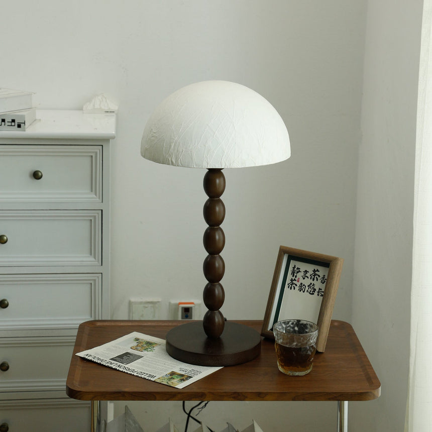 Close view of the stacked wood bobbins and the round disc foot