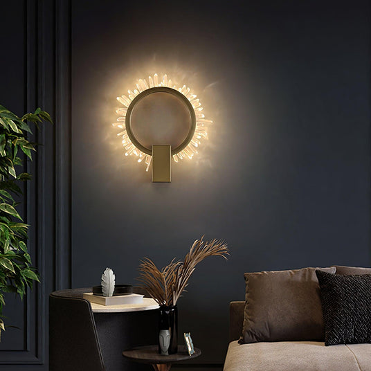 The ring lit on a dark wall above a sofa with cushions and a round side table