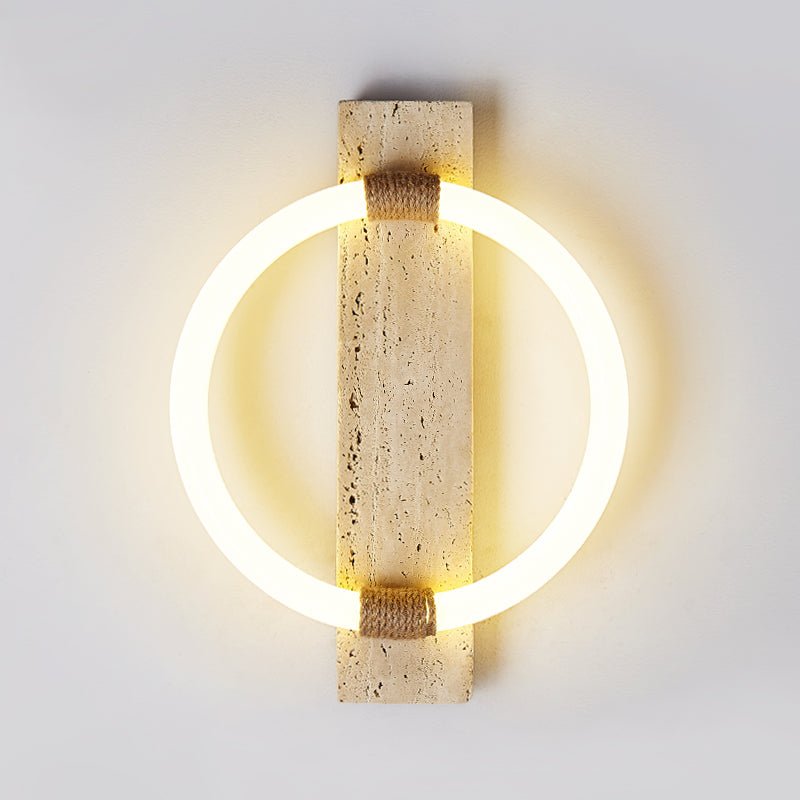 The ring lit warm around the travertine slab, the stone pores visible in the glow