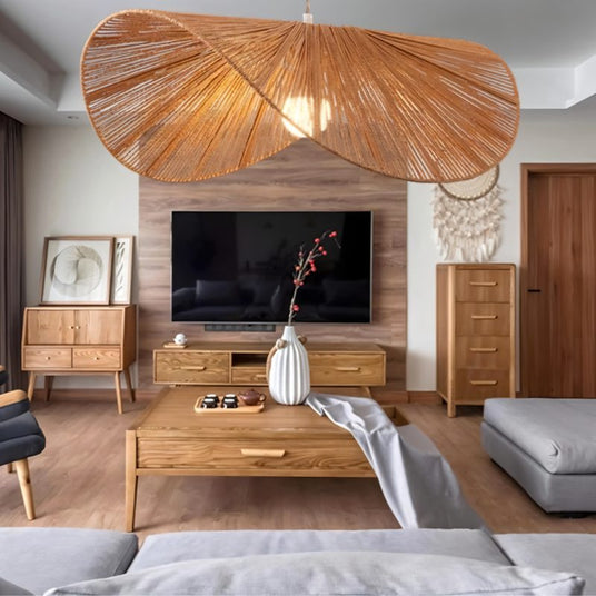 The shade lit in a living room above a long console with a vase and a low sofa