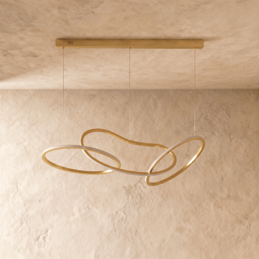 The three loop version in gold, rings crossing over each other on two cables